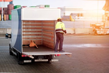 Empty Cargo Truck With Opened Ramp Operated By Driver And Hydraulic Lifting Trolley Inside Designed For Pallet Transportation. Commercial Vehicle For  Goods Logistics And Parcel Delivery.