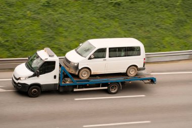 Tow Truck Hauling On Flatbed Passenger Van for Reliable Roadside Assistance and Vehicle Recovery clipart