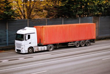 White Semi-Truck Hauling Large Red Shipping Container clipart