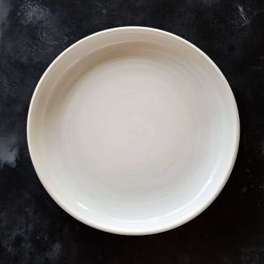 empty ceramic plate on a black background