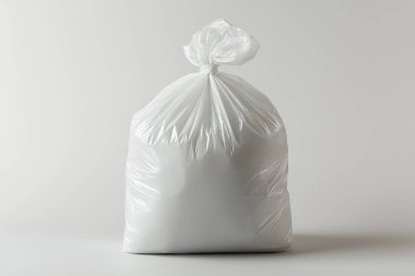 white plastic trash bag with white paper bag.