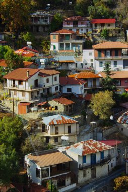 A charming view of Moutoullas village in Cyprus, showcasing traditional houses with tiled roofs nestled on a hillside. A picturesque representation of Mediterranean rural life and culture. clipart