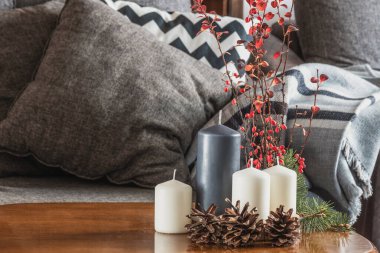 Mumlar, koniler ve dallarla kış tatili masa düzenlemesi.