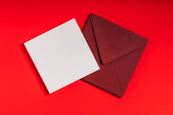 Red envelope and blank form on red background. Postcard or greeting layout.
