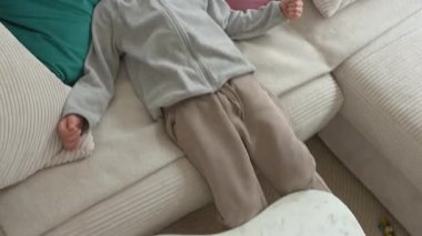 Beyaz bir masada renkli manyetik bloklarla oynayan bir çocuğun üst görüntüsü. Çocuk odaklanmış ve meşgul, sakin bir ortamda yaratıcı oyun ve gelişme becerileri sergiliyor..