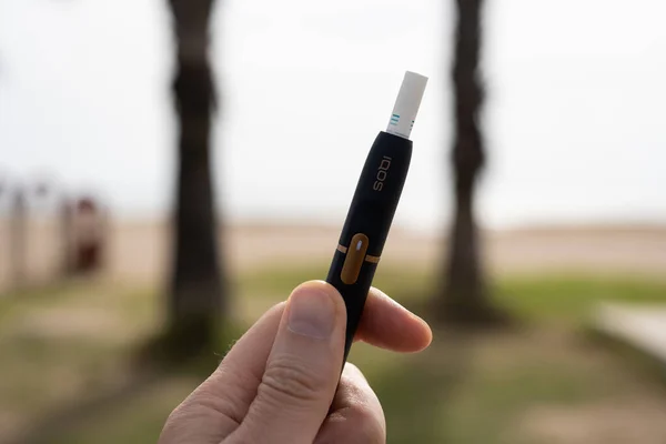 stock image Tarragona, Spain - October 29, 2022: Phillip Morris Internationals Marlboro IQOS, electronic cigarette in a mans hand.