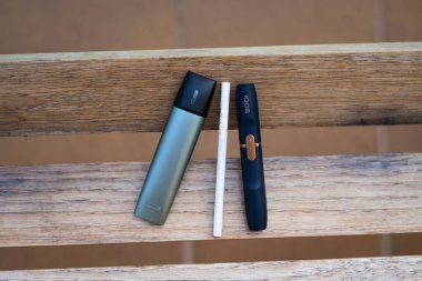Tarragona, Spain - September 16, 2022: Electronic cigarettes IQOS close-up. Different options for smoking and cigarette. Choice of devices for the use of nicotine. clipart
