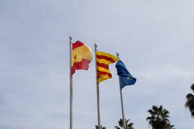 Flags spain european union catalonia on blue sky background
