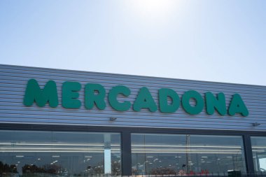 Tarragona, Spain - February 02 2023: Mercadona supermarket logo on blue sky background.