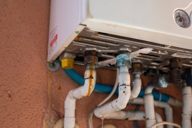Rusty pipe on a gas boiler close-up.