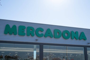 Tarragona, Spain - February 02 2023: Mercadona supermarket logo on blue sky background.