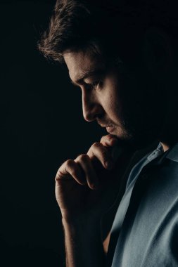 The young guy thought. Portrait on a dark background.