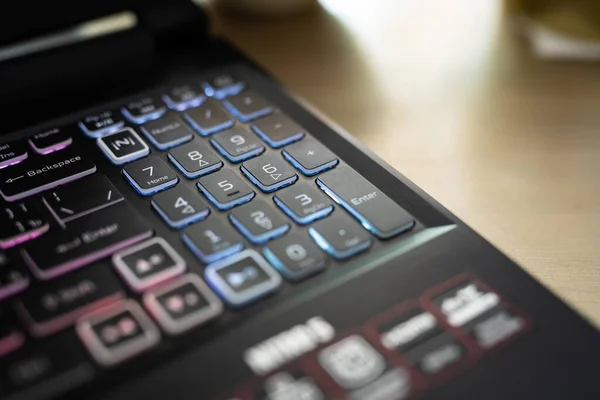 Red backlit keyboard close up. Gaming laptop.