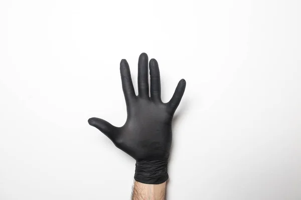 Medische Zwarte Handschoenen Een Mannelijke Hand Een Witte Achtergrond — Stockfoto