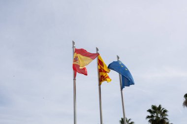 Flags spain european union catalonia on blue sky background