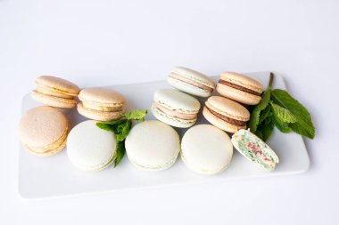 Beyaz arkaplanda nane aromalı farklı renkte makarnalar..