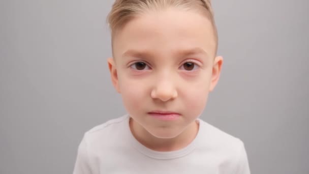 Mały Chłopiec Białej Koszulce Patrzy Troskliwie Kamerę Uśmiecha Się Szczęśliwie — Wideo stockowe