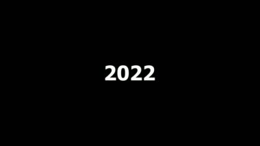 2022, 2023 ve 2004 numaralarının animasyonu. Siyah zemin üzerinde beyaz sayılar bulunan yeni yıl takvimi.