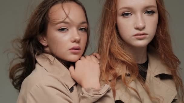 Zwei Stylische Models Trenchcoat Studio Vor Grauem Hintergrund — Stockvideo