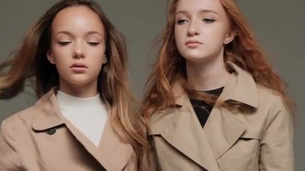 Two Stylish Models Trench Coat Studio Gray Background — Stock Video