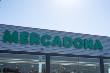 Tarragona, Spain - February 02 2023: Mercadona supermarket logo on blue sky background.