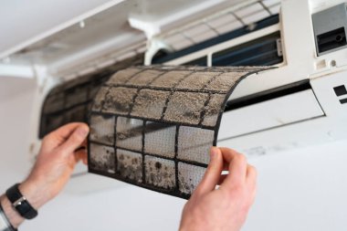 Air conditioner filter dusty. Preparation for maintenance and cleaning. clipart