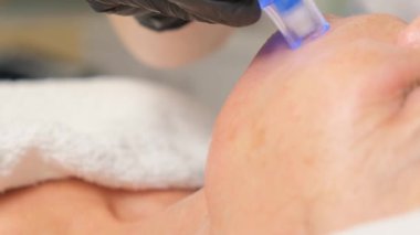 Güzellik uzmanının cilt bakımı sırasında güzel bir kadının yakın plan portresi..