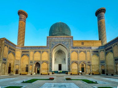 A breathtaking view of the Registan Ensemble in Samarkand, Uzbekistan, captured at sunrise. The intricate mosaic patterns, the grandeur of the turquoise domes, and the towering minarets reflect the clipart