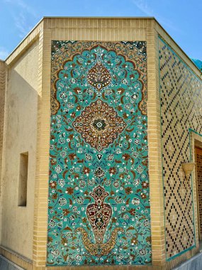 A beautifully crafted Islamic wall adorned with turquoise floral tile mosaics and intricate geometric patterns. This stunning piece of traditional art showcases the elegance and cultural richness of clipart