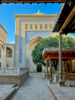 A stunning view of a historic building in Khiva, Uzbekistan. The facade is adorned with exquisite blue and white tile patterns, characteristic of Islamic architecture in Central Asia. In the clipart