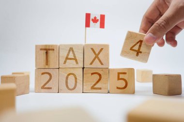 Wooden blocks spelling 'TAX 2025' with a Canadian flag, symbolizing upcoming taxation year insights and planning clipart