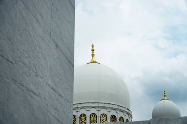 Image showcasing a beautiful Sheikh Zayed Grand Mosque with intricate architecture, featuring golden details and a stunning dome, set against a soft cloudy sky, evoking tranquility and spirituality clipart