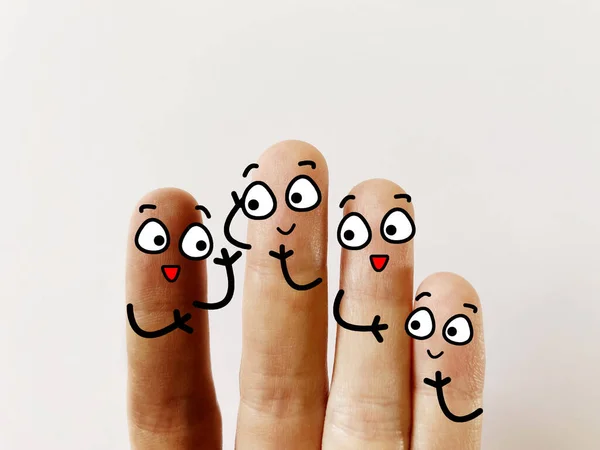 stock image Four fingers are decorated as four person. One of them are foreigner. They respect each other.