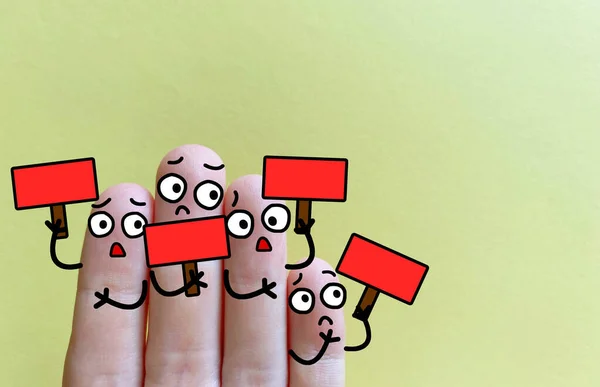 Four fingers are decorated as four person. All of them are holding red boards.