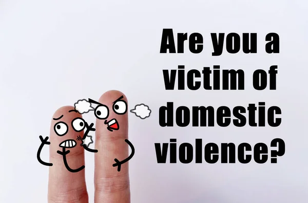 Two fingers are decorated as two person. One of them is a victim of domestic violence.