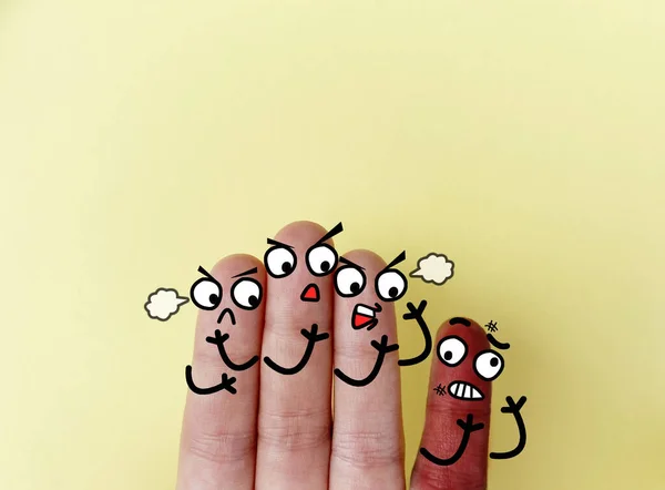 Four fingers are decorated as four person. One of them is a victim of bullying.