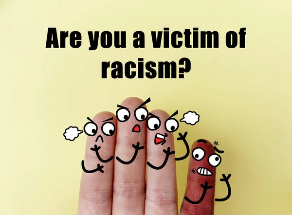 Four fingers are decorated as four person. One of them is a victim of racism.