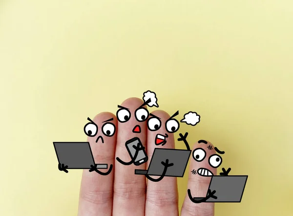 Four fingers are decorated as four person. They are involved in cyber bullying.