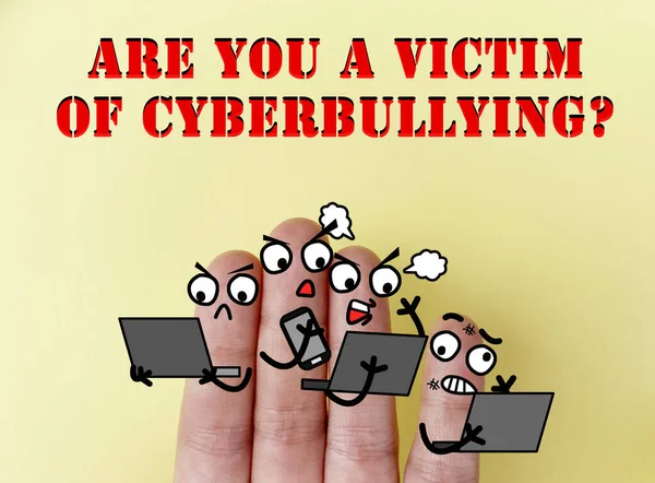 Four fingers are decorated as four person. One of them is a victim of cyberbullying.