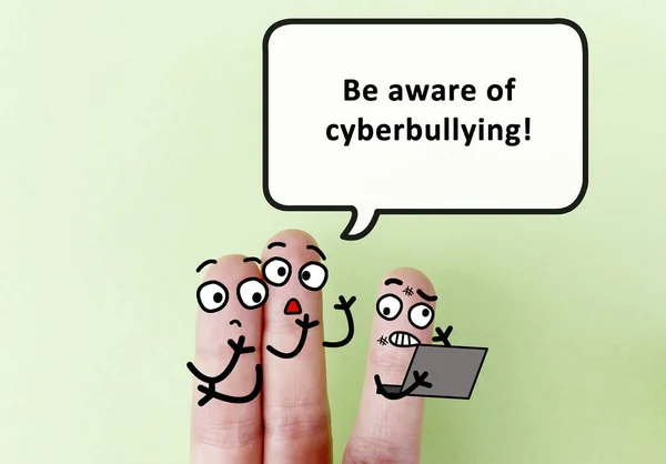 Three fingers are decorated as three person. One of them is telling another to be aware of cyberbullying.