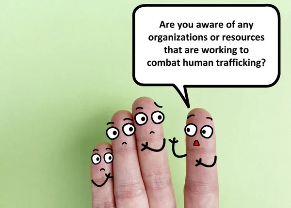 Four fingers are decorated as four person. One of them is asking others if they are aware of any organizations or resources that are working to combat human trafficking.