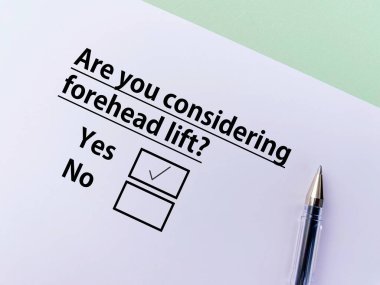 A person is answering question about cosmetic surgery. She is considering forehead lift.