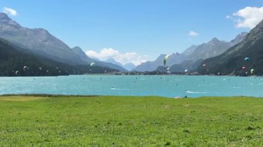 İsviçre, Engadin 'deki Silvaplanersee' de kaykaya binmek. Birçok Kiteboardcu, Sankt Moritz yakınlarında bir yaz günü numaralarını gösteriyor. Yüksek kalite 4k görüntü