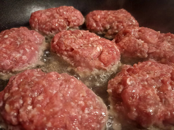 balls of minced meat on the grill. Cutlets are fried in a pan