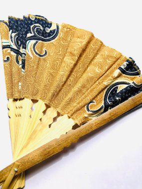 Indonesia batik fan - a traditional hand fan, mostly known as traditional hand made for souvenir clipart