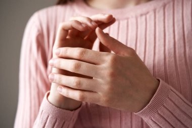 Young teenage girl practicing EFT or emotional freedom technique - tapping on the side of the hand point