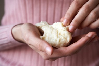 Raw unrefined shea butter or karite in the hands of a young woman