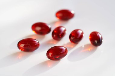Krill oil pills or capsules on a bright background