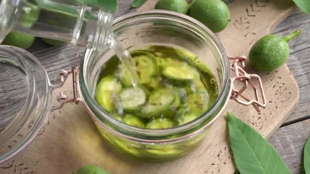 Pouring Alcohol Flass Jar Filled Green Unripe Walnuts Preparation Homemade — Αρχείο Βίντεο
