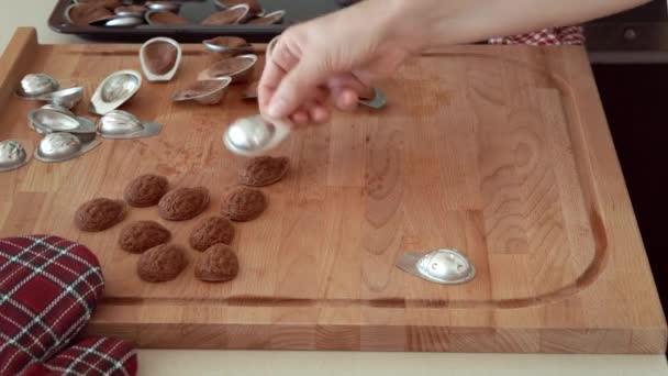 Knocking Baked Nut Shaped Christmas Cookies Out Tin Moulds — Stock video